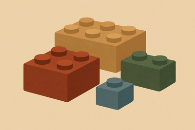 Quatre blocs de construction Lego de différentes couleurs, allant d'un petit bloc à 1 picot à un grand bloc à 6 picot.